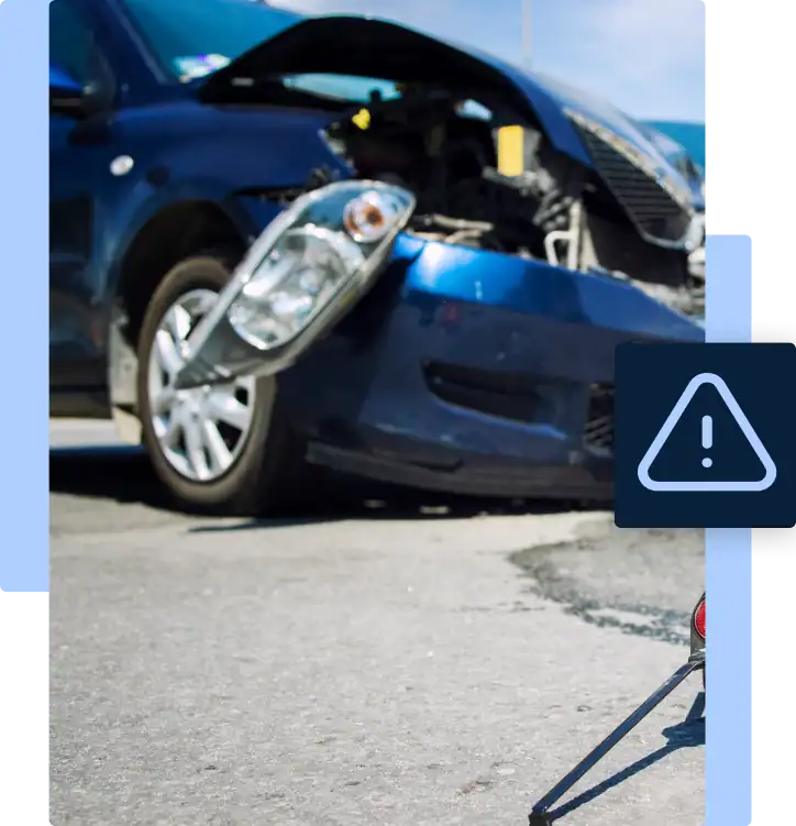 Front-end damage to a blue car after a motor vehicle accident, with a roadside warning triangle in place