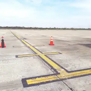 Empty airport runway with cones blocking part of the path, suggesting unsafe conditions
