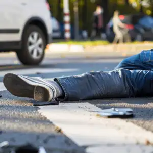 Pedestrian lying on crosswalk after being hit by a car