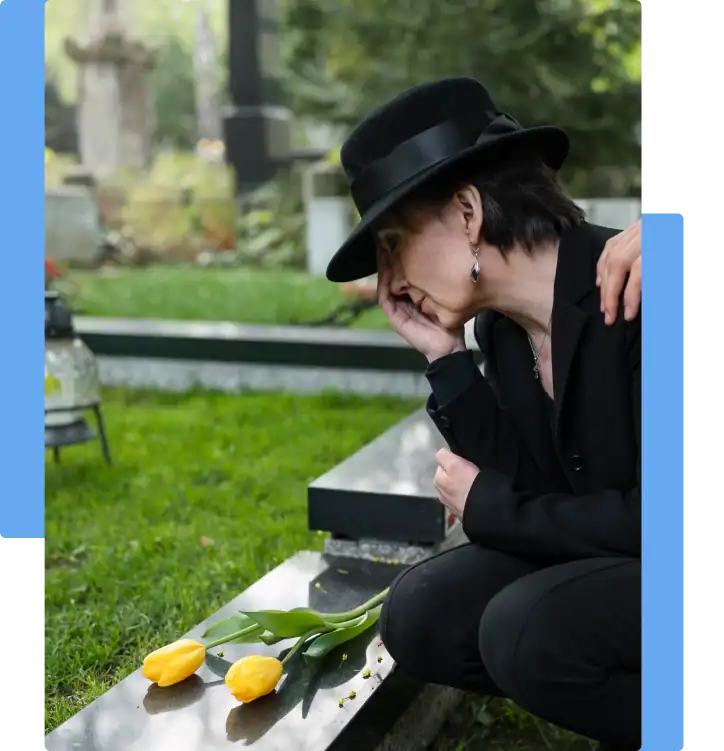 wrongful death Grieving woman in black at a gravesite with yellow tulips, comforted by a hand on her shoulder — symbolizing loss and mourning after a wrongful death