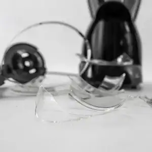 Household appliance with shattered glass pieces on the floor, illustrating injury risk from a defective product